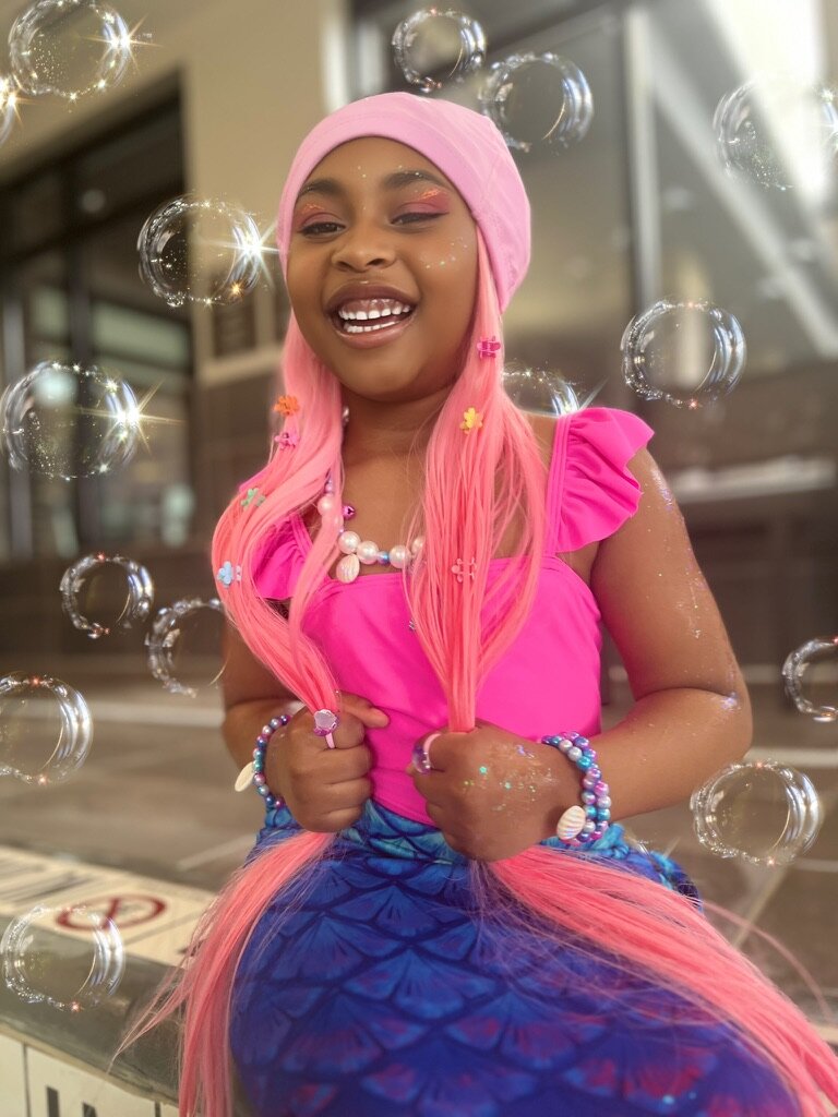 Black girl with gorgeous pink SwimHair — bubbles and smiles