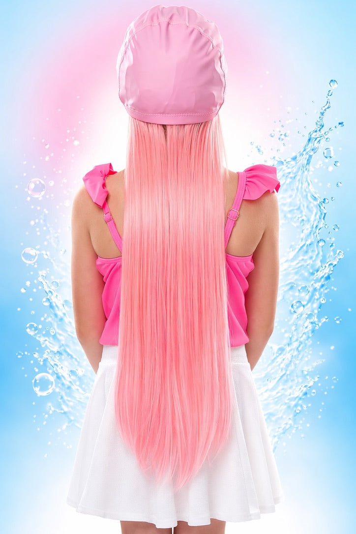 Girl showing SwimHair cap with long pink hair — water splash